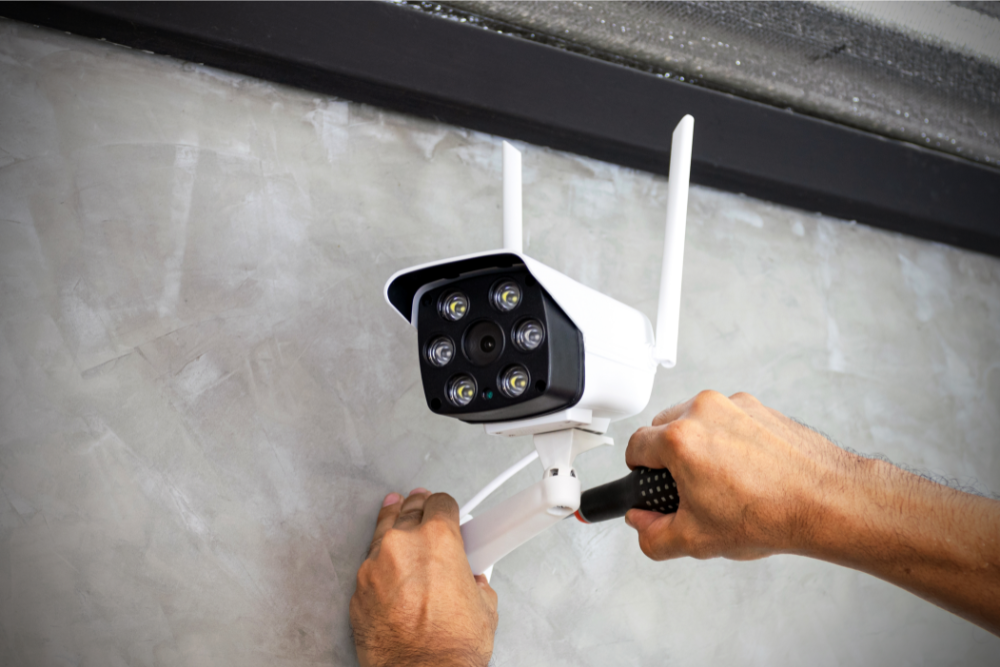 Technician mounting and adjusting an outdoor security camera